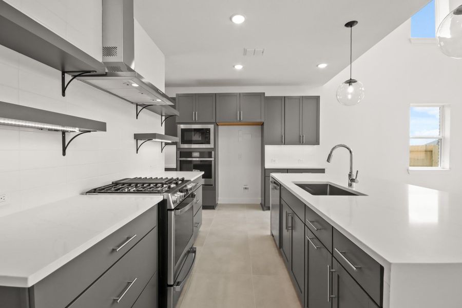 Gourmet kitchen with grey cabinets and quartz counters Gourmet kitchen with grey cabinets and quartz counters