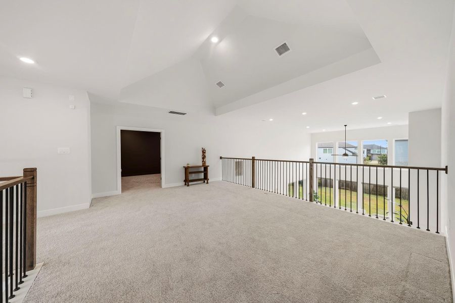 The spacious game room is enhanced by a dramatic cathedral ceiling, plush carpeting and recessed light, creating an impressive yet comfortable setting for game nights or relaxed entertaining.