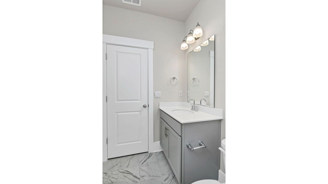 Representative furnished interior of a home built from the Litchfield by D.R. Horton in Lake Tide Summit, Chapin (Image 16).