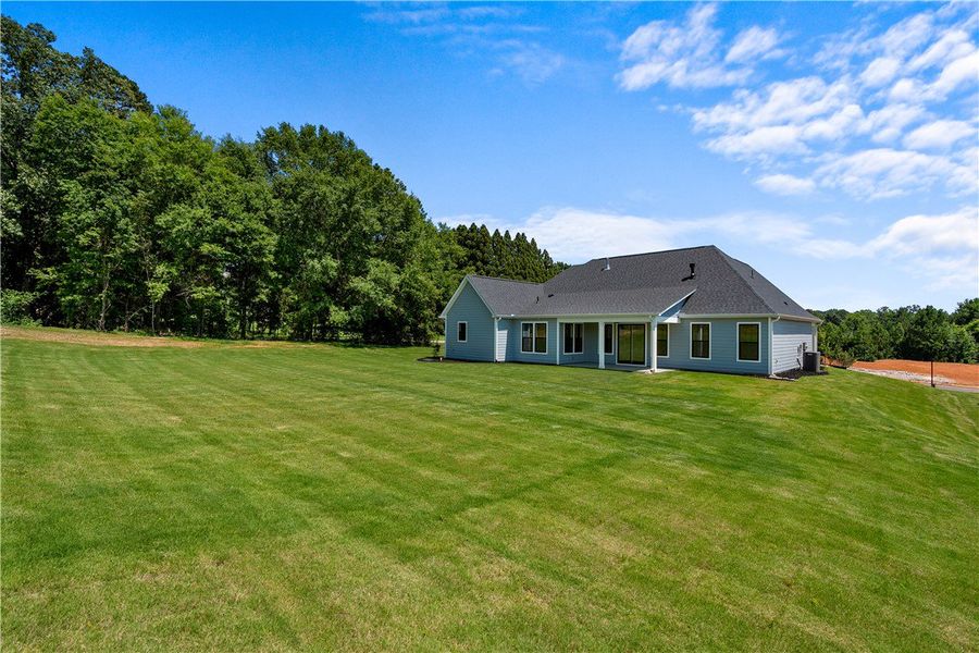 A sprawling green lawn surrounds this contemporary