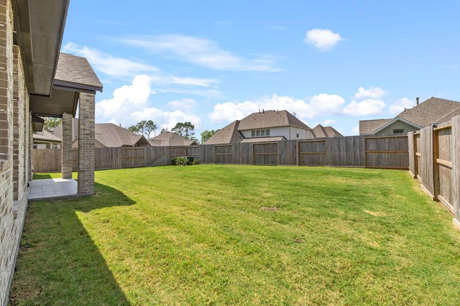 Front exterior of a new home in Riceland 70', Mont Belvieu, TX, highlighting curb appeal (Image 23).
