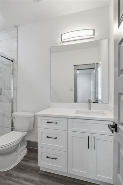 White vanity with shaker-style cabinetry, a built-in sink, and a single-handle faucet