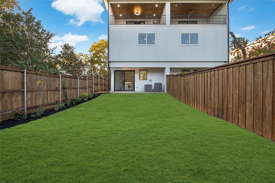 Back of house with a patio area and a fenced backyard
