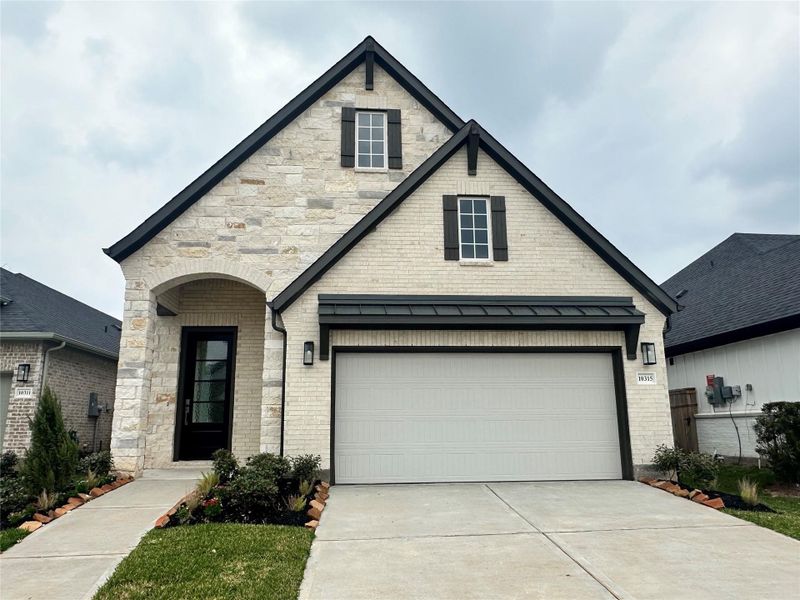 Front exterior of a new home in Sienna, Missouri City, TX, highlighting curb appeal (Image 2).