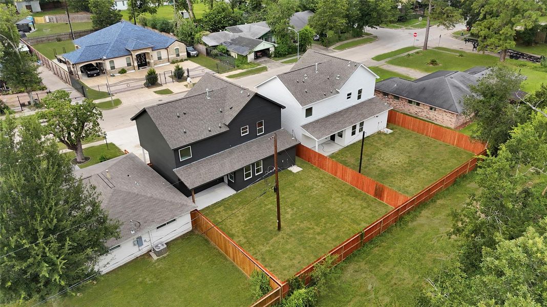 Bird’s-eye view of home, fencing, and green space. Bird’s-eye view of home, fencing, and green space.