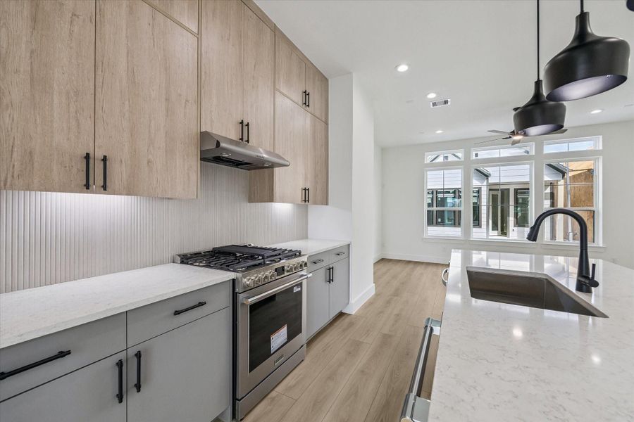 Well-planned kitchen layout with generous prep space and refined finishes Well-planned kitchen layout with generous prep space and refined finishes