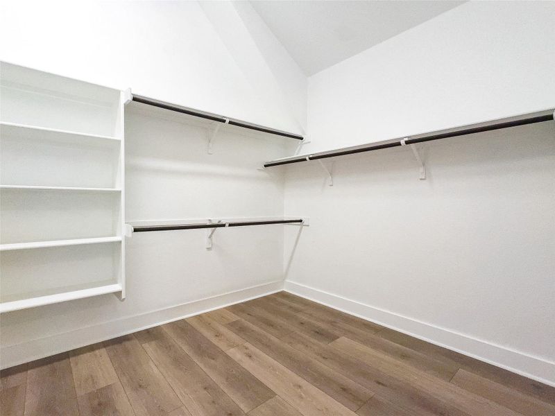 Walk in closet featuring light wood-type flooring Walk in closet featuring light wood-type flooring