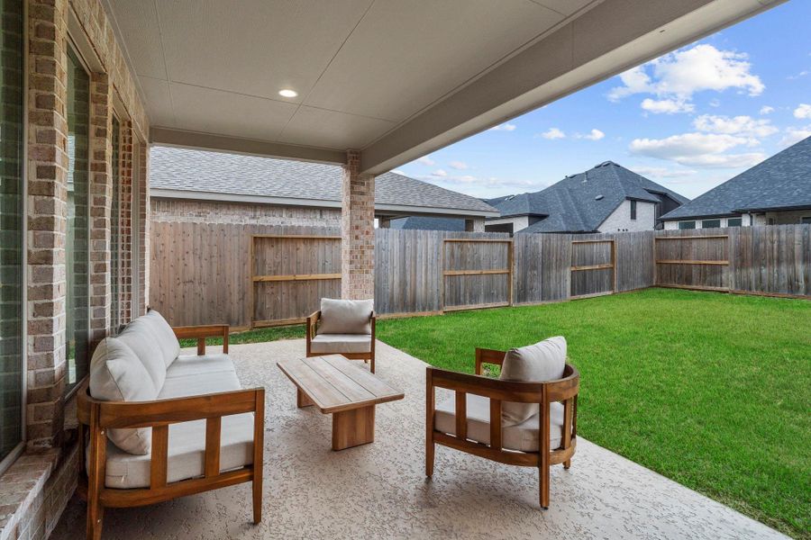 Seamless indoor-outdoor flow with a glass-panel rear door and large windows leading from the main living area to the patio. Seamless indoor-outdoor flow with a glass-panel rear door and large windows leading from the main living area to the patio.