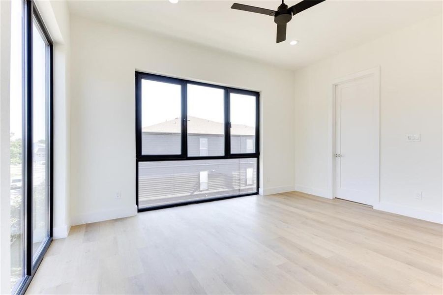 Unfurnished room with ceiling fan and light hardwood / wood-style floors