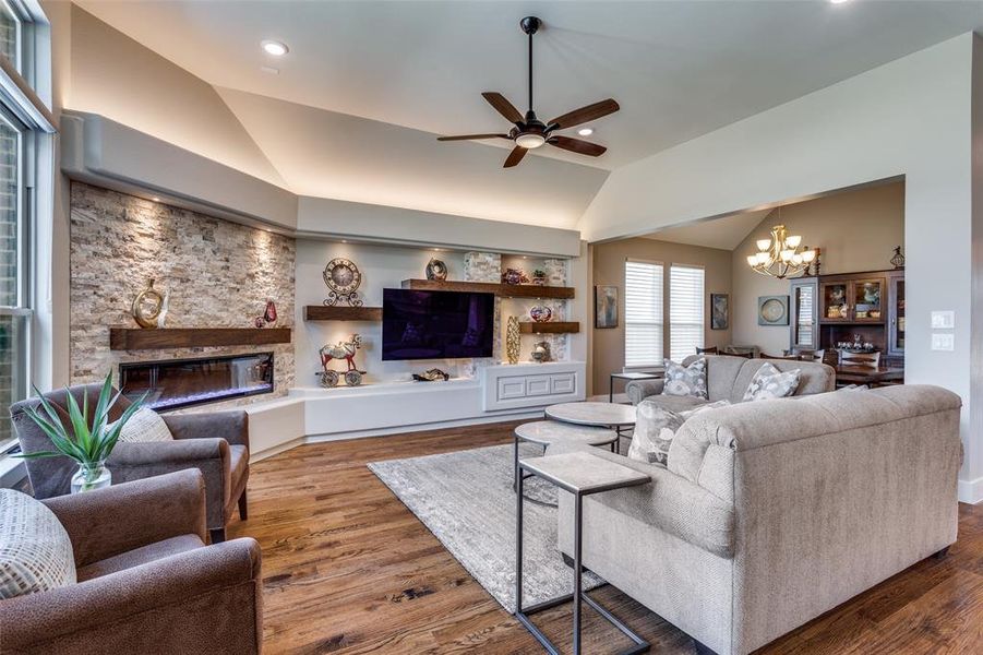 Ledger stone details paired with floating shelves create a striking designer focal point