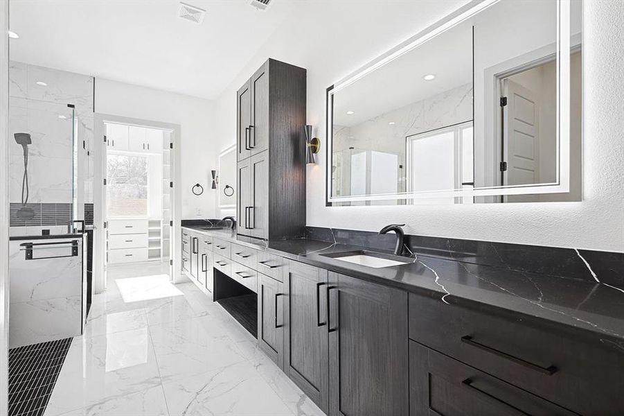 Bathroom with vanity and tiled shower