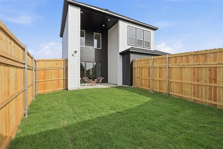 Rear view of property with a patio and a fenced backyard