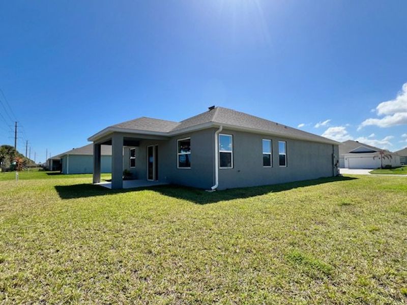Exterior details and patio area of a home in Lakes At St Sebastian, Micco (Image 19).
