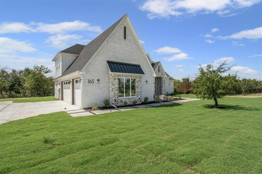 View of front of property with brick siding, a front yard, concrete driveway, and roof with shingles View of front of property with brick siding, a front yard, concrete driveway, and roof with shingles