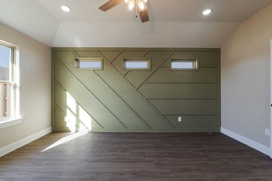 Unfurnished room featuring a ceiling fan, dark wood-type flooring, vaulted ceiling, and recessed lighting