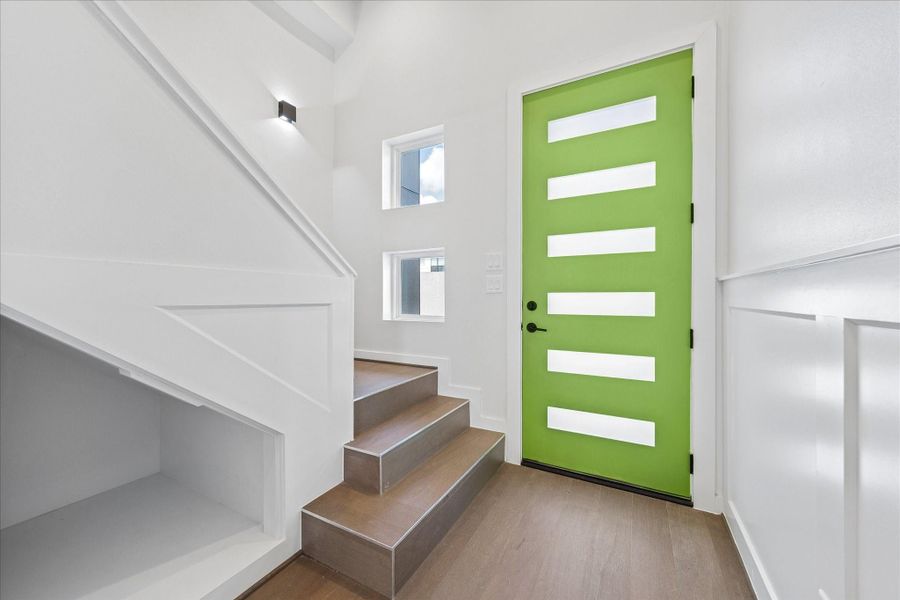Contemporary entry highlighted by a bold designer front door, soaring ceilings, and clean architectural detailing. Contemporary entry highlighted by a bold designer front door, soaring ceilings, and clean architectural detailing.