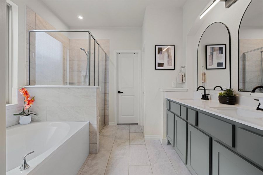 The ensuite bath features a dual vanity, a soaking tub, a separate shower, and a layout that keeps everything feeling organized and easy to use. Updated Vanity fixtures and lighting.