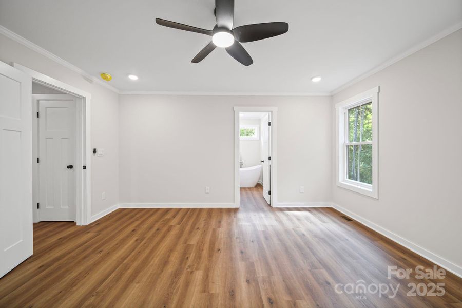 Primary bedroom with walk-in closet. Primary bedroom with walk-in closet.