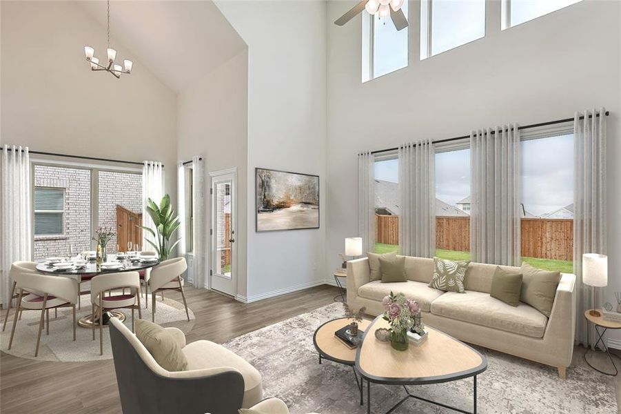 Living room featuring a healthy amount of sunlight, wood-type flooring, and a high ceiling