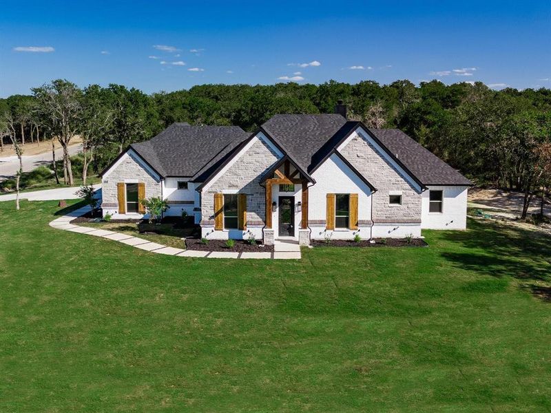 Front exterior of a new home in , Weatherford, TX, highlighting curb appeal (Image 24).