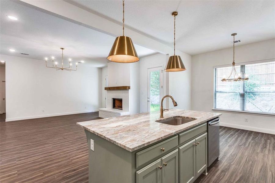Kitchen featuring a chandelier, a sink, stainless steel dishwasher, dark wood finished floors, and recessed lighting