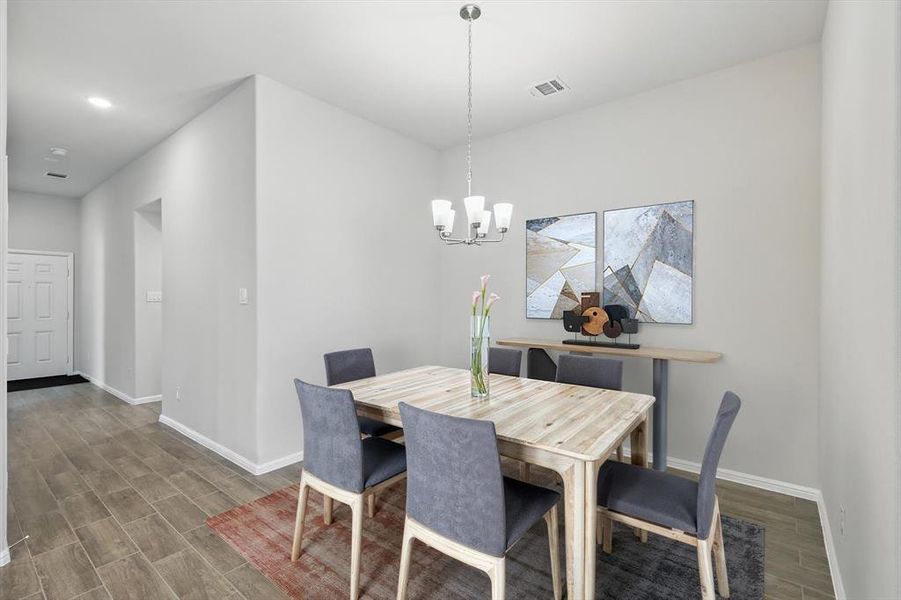 Dining room featuring wood finish floors, a chandelier, and recessed lighting Dining room featuring wood finish floors, a chandelier, and recessed lighting