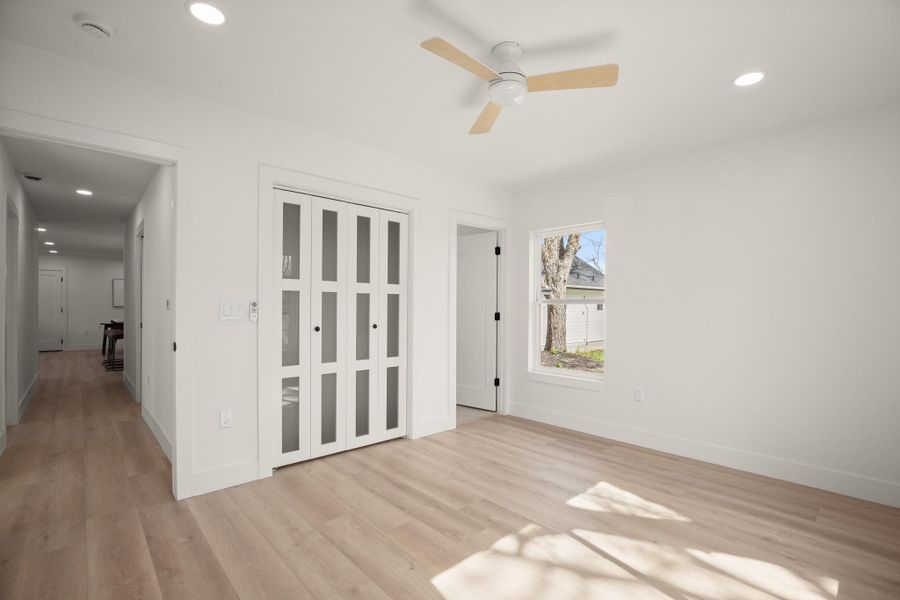 Empty room featuring recessed lighting, light wood-style flooring, and a ceiling fan