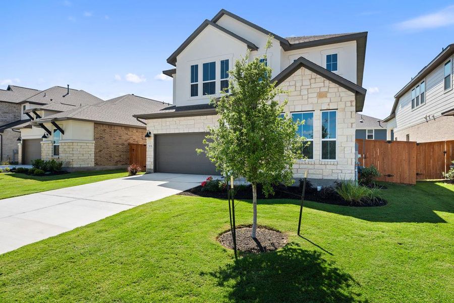 Front exterior of a new home in Lariat, Liberty Hill, TX, highlighting curb appeal (Image 1). Front exterior of a new home in Lariat, Liberty Hill, TX, highlighting curb appeal (Image 1).