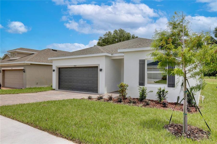 Front exterior of a new home in , Groveland, FL, highlighting curb appeal (Image 19).