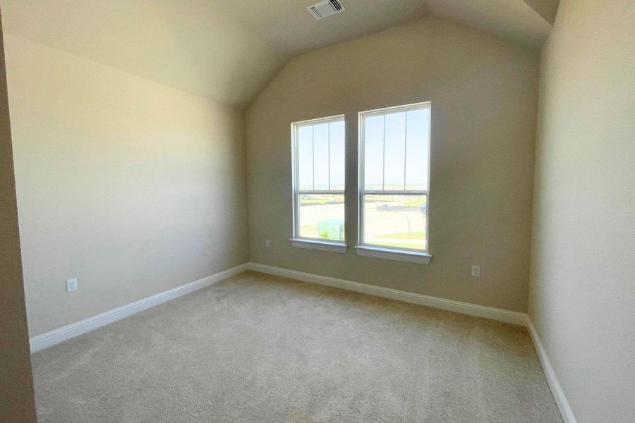 Vaulted ceilings and plush carpeting define this inviting bedroom space with double windows. Vaulted ceilings and plush carpeting define this inviting bedroom space with double windows.