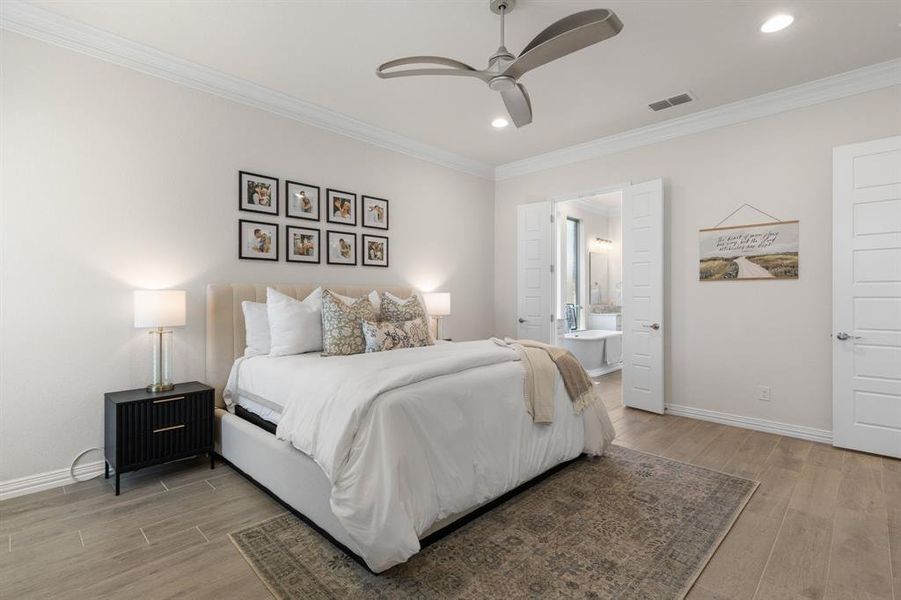 Bedroom featuring light wood-style floors, crown molding, ceiling fan, connected bathroom, and recessed lighting Bedroom featuring light wood-style floors, crown molding, ceiling fan, connected bathroom, and recessed lighting