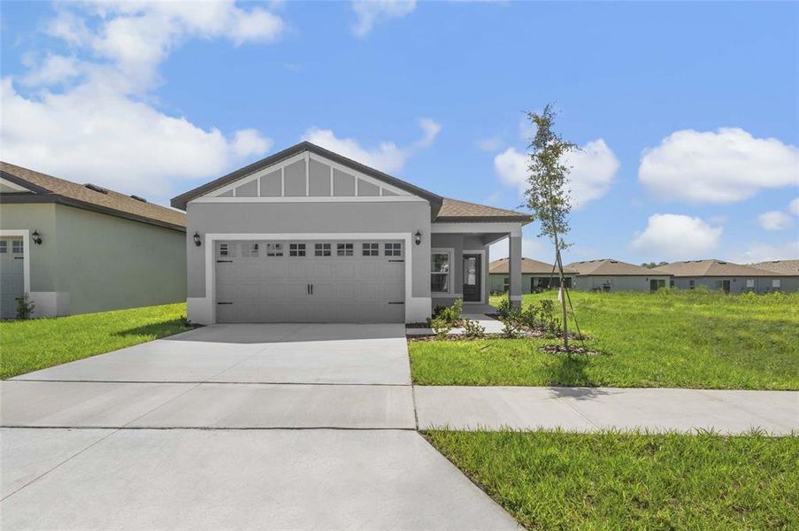 Front exterior of a new home in Gum Lake Preserve, Lake Alfred, FL, highlighting curb appeal (Image 17).
