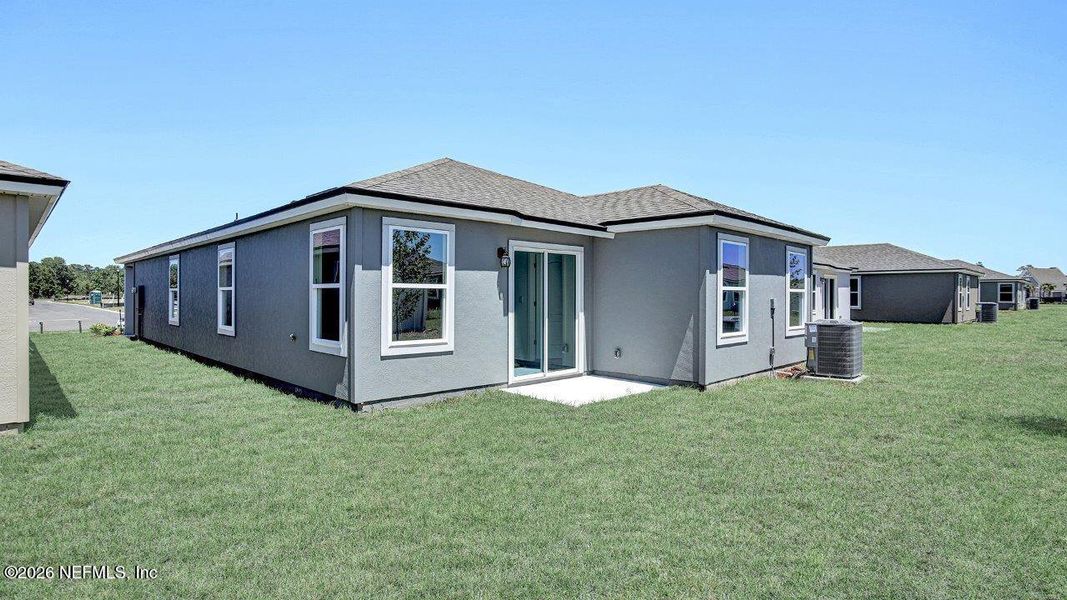 Exterior details and patio area of a home in Grand Reserve, Bunnell (Image 2).