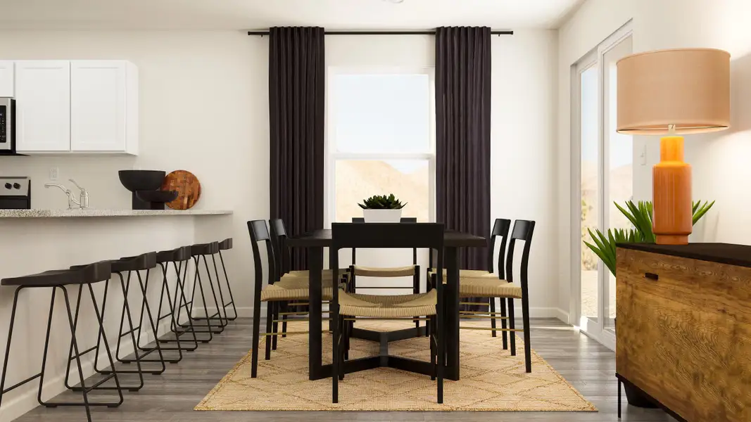 A dining room with a table and chairs.
