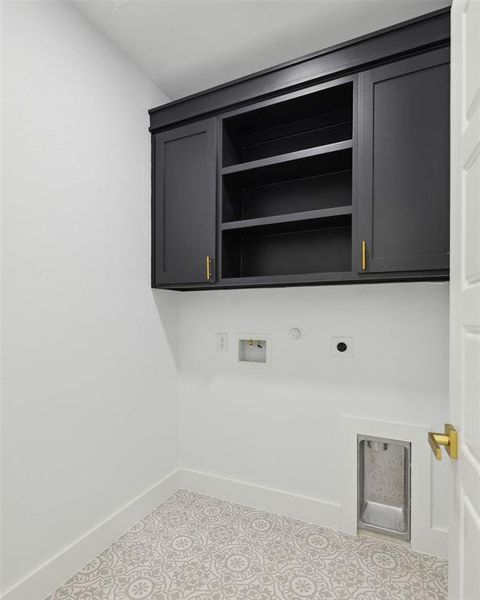 Washroom featuring cabinets, hookup for an electric dryer, hookup for a gas dryer, and hookup for a washing machine