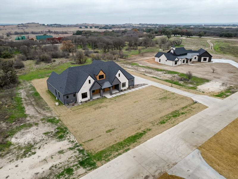 Front exterior of a new home in Summit Ranch, Aledo, TX, highlighting curb appeal (Image 30). Front exterior of a new home in Summit Ranch, Aledo, TX, highlighting curb appeal (Image 30).