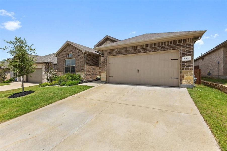 View of front of home with brick siding, a front lawn, and concrete driveway View of front of home with brick siding, a front lawn, and concrete driveway