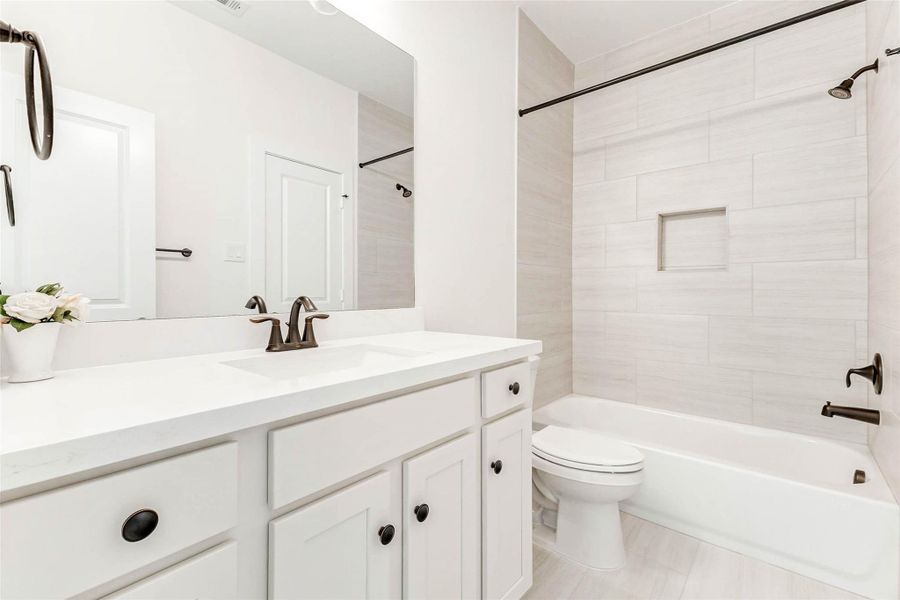 Connects bedrooms two and three.Features floor-to-ceiling tile, a niche for toiletries, and soft-close cabinetry for a refined finish.