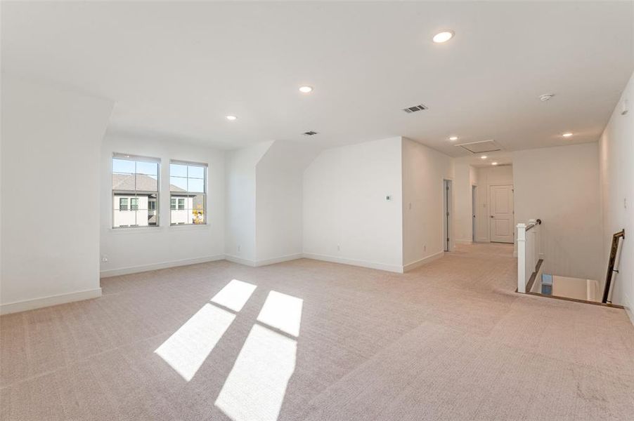 Spare room with light colored carpet, recessed lighting, and attic access Spare room with light colored carpet, recessed lighting, and attic access