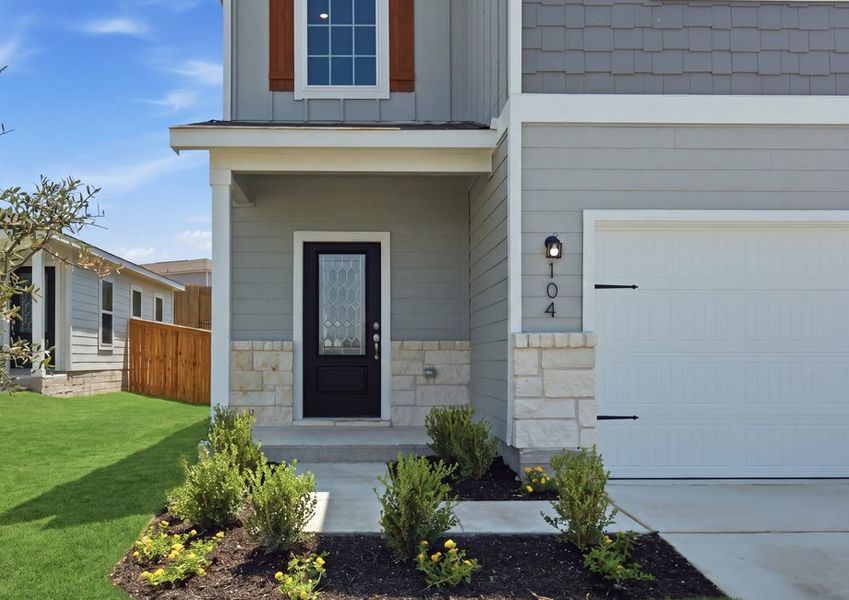 Two-story Torres floor plan front exterior featuring lap siding, a two-car garage, and landscaped front lawn. Two-story Torres floor plan front exterior featuring lap siding, a two-car garage, and landscaped front lawn.