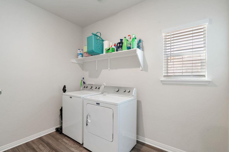 Dedicated laundry room with washer/dryer connections, shelving, and window for natural light. Dedicated laundry room with washer/dryer connections, shelving, and window for natural light.