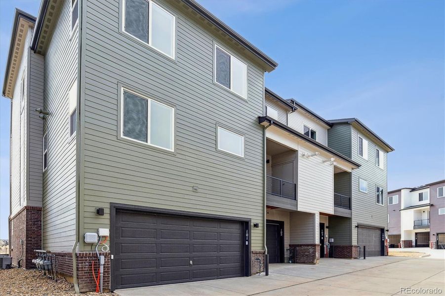 Exterior details and patio area of a home in Townhome Collection at Grand Vue at Interlocken, Broomfield (Image 2).