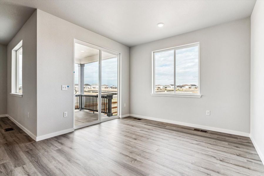 A room with a wood floor and a wood floor with a window.