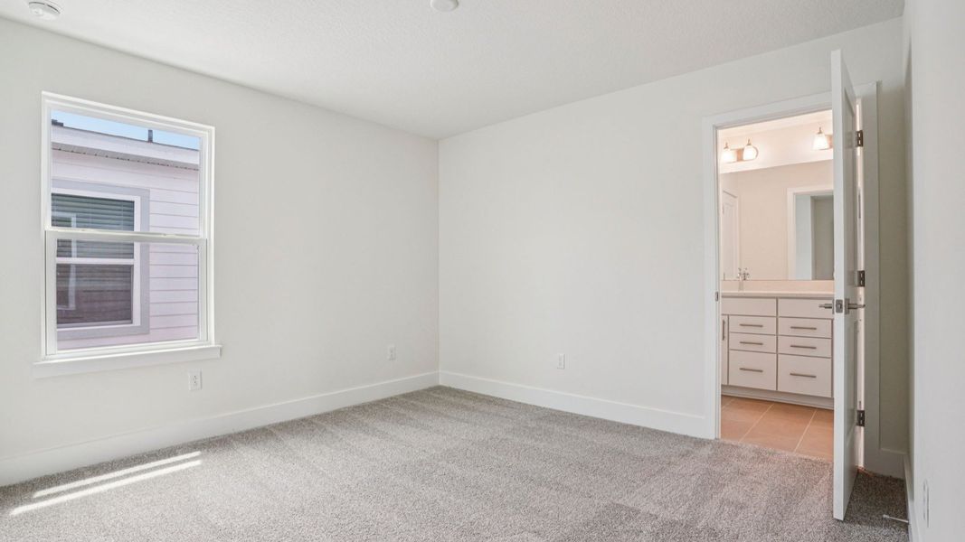 Bedroom with closet in the Plumeria plan at Lakeside at Satilla by DRB Homes. Bedroom with closet in the Plumeria plan at Lakeside at Satilla by DRB Homes.