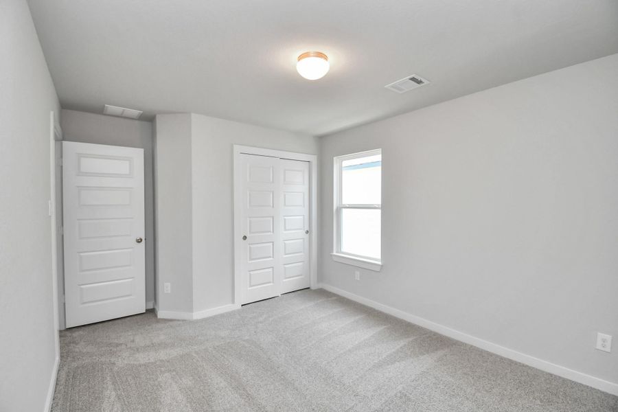 Generously sized secondary bedrooms featuring spacious closets, soft and inviting carpeting underfoot, large windows allowing plenty of natural light, and the added touch of privacy blinds for your personal retreat. Generously sized secondary bedrooms featuring spacious closets, soft and inviting carpeting underfoot, large windows allowing plenty of natural light, and the added touch of privacy blinds for your personal retreat.