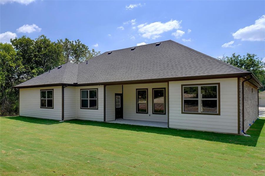 Back of property featuring a yard and a patio