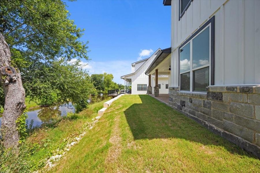 View of grassy yard with a water view