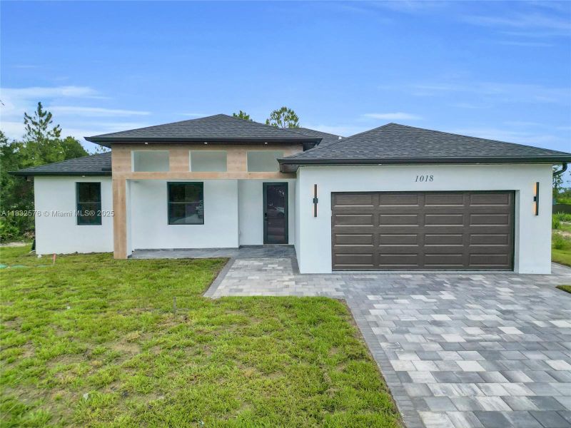 Front exterior of a new home in , Lehigh Acres, FL, highlighting curb appeal (Image 32).