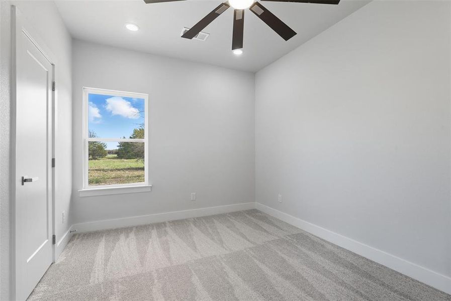 Empty room with light carpet, recessed lighting, and a ceiling fan Empty room with light carpet, recessed lighting, and a ceiling fan