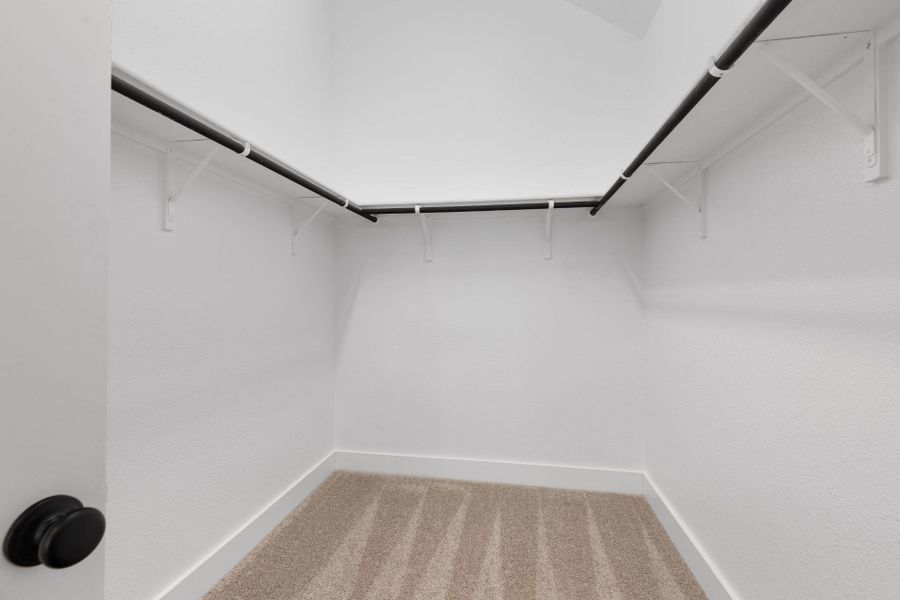 Walk-in closet in Primary Bedroom Walk-in closet in Primary Bedroom